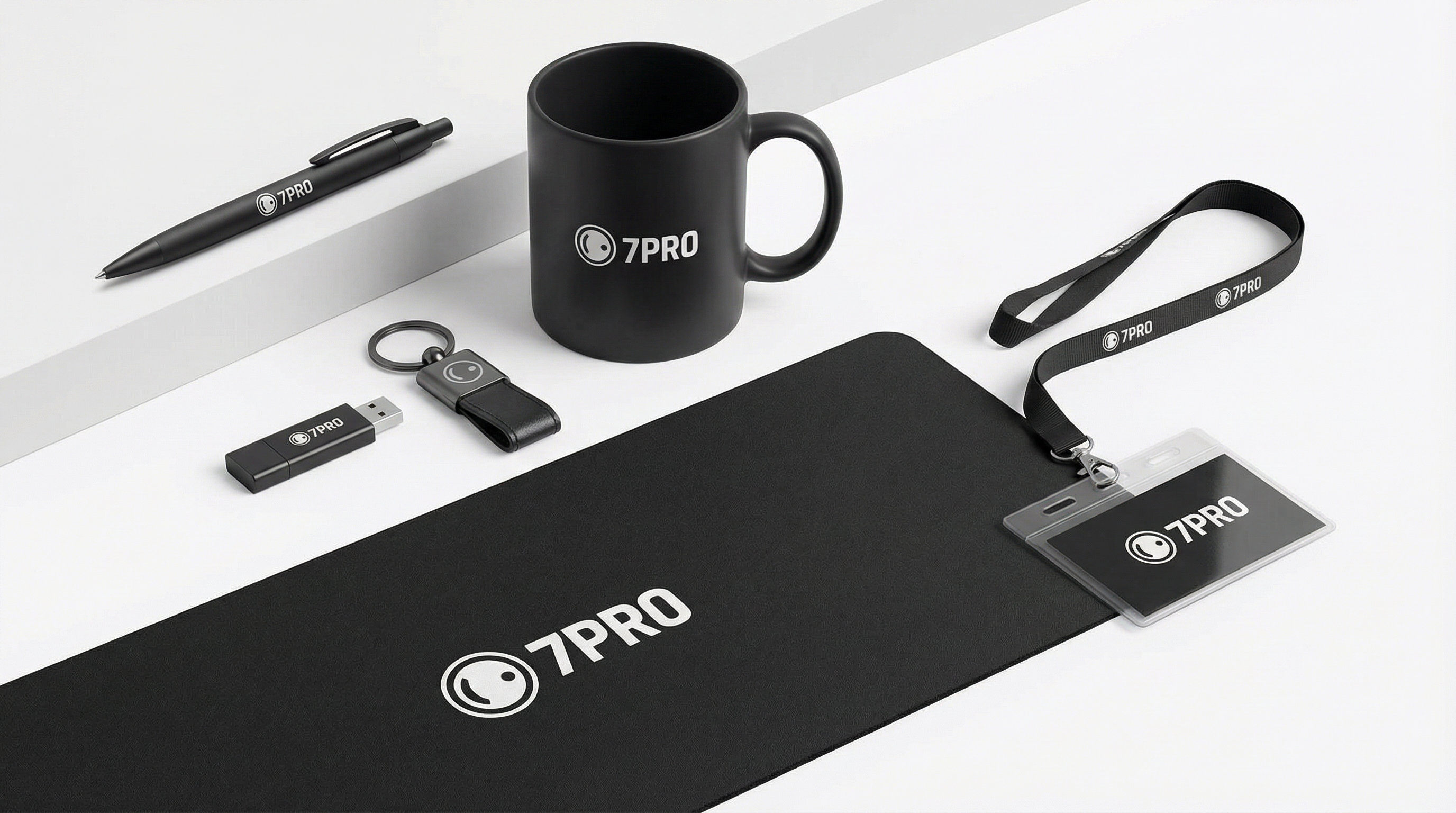 7PRO LLC promotional materials including branded pen, USB drive, keychain, mug, mousepad, and lanyard with ID holder